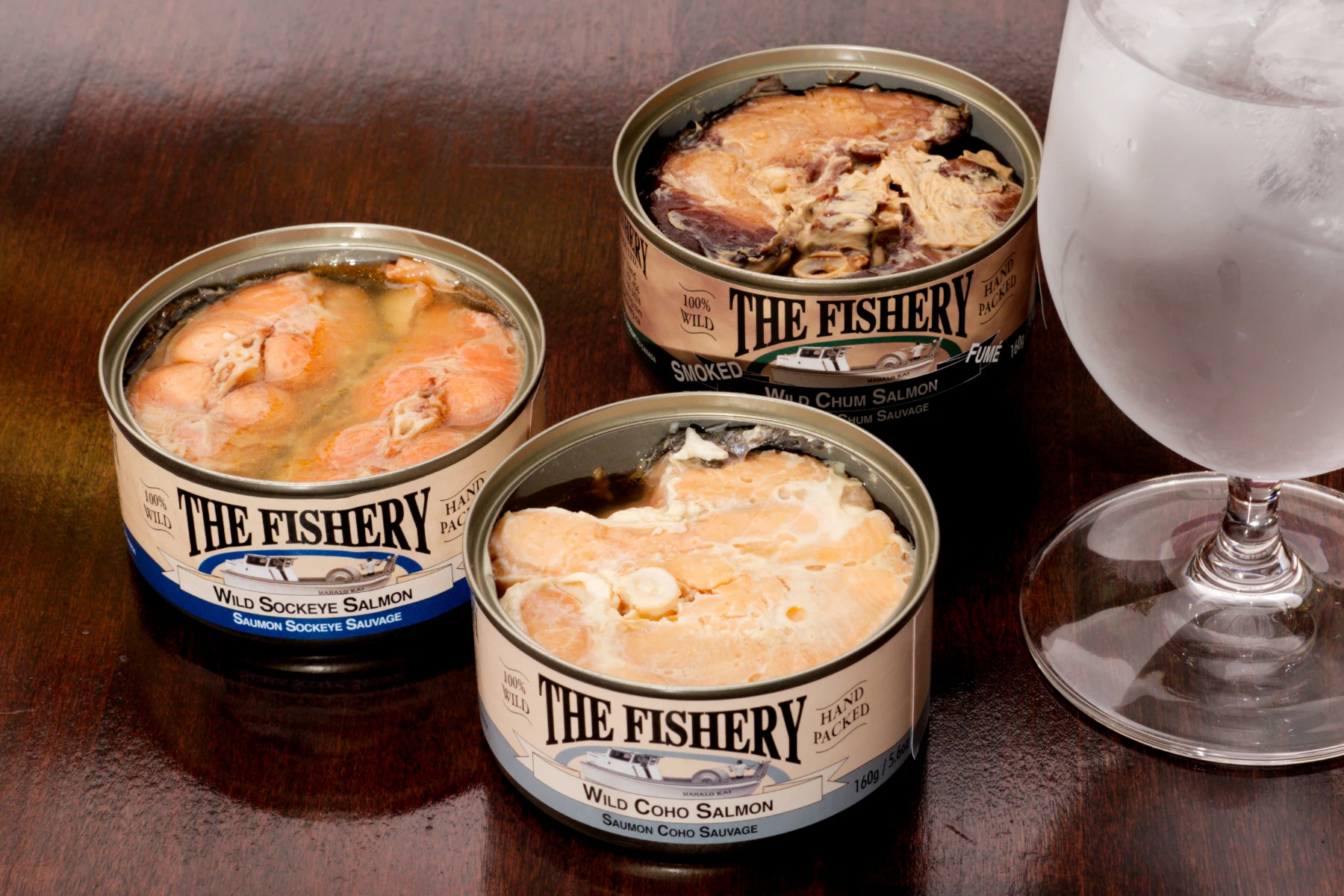 Three salmon cans, opened.
