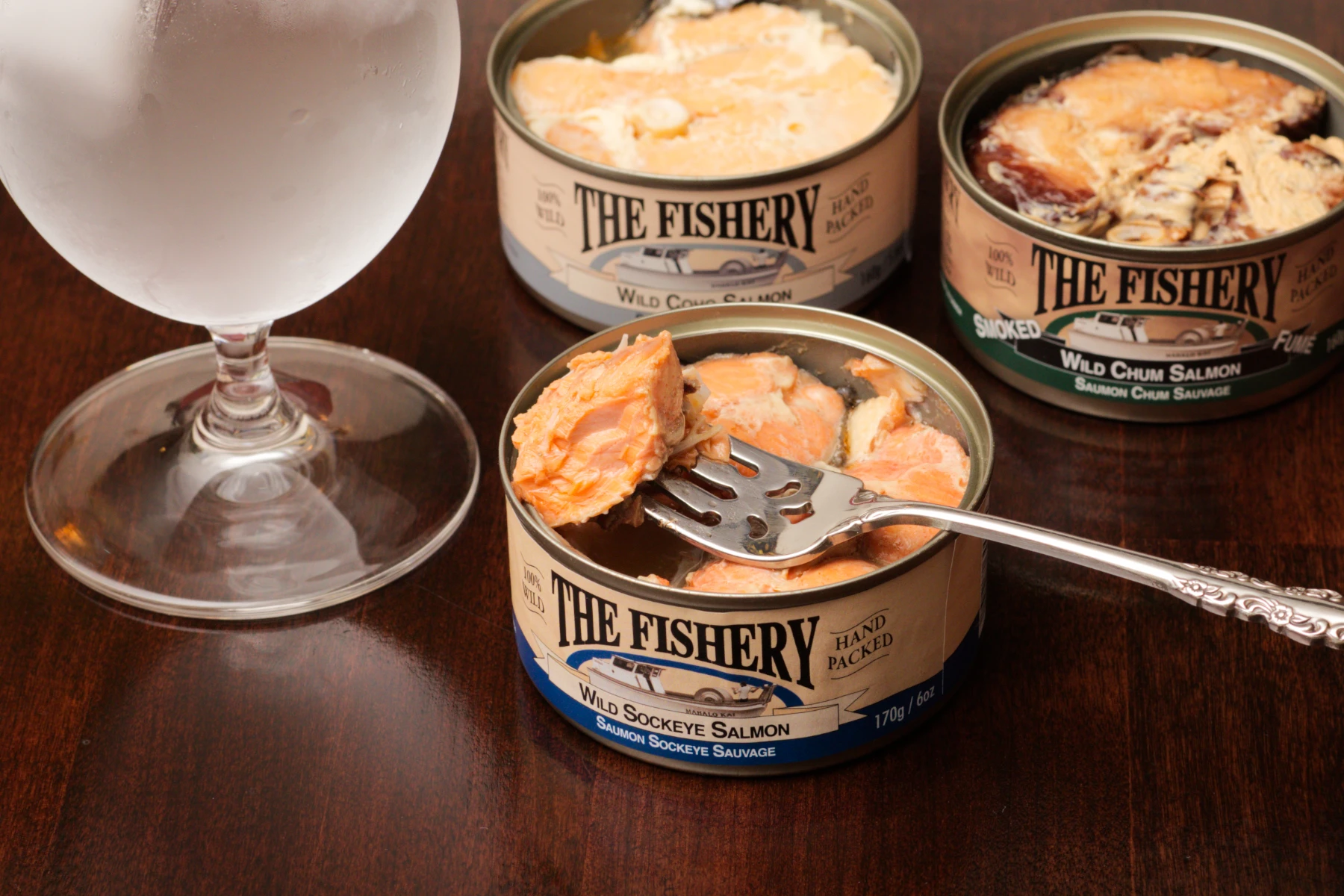 Sockeye salmon can, morsel on fork.