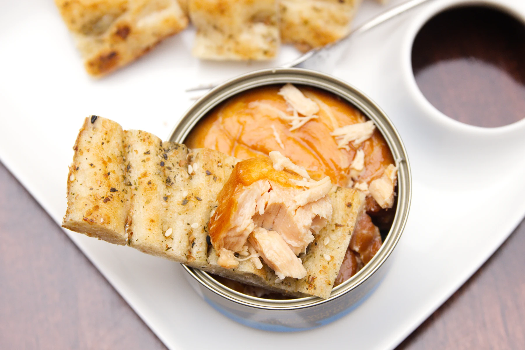 A piece of sturgeon meat on a strip of garlic flatbread