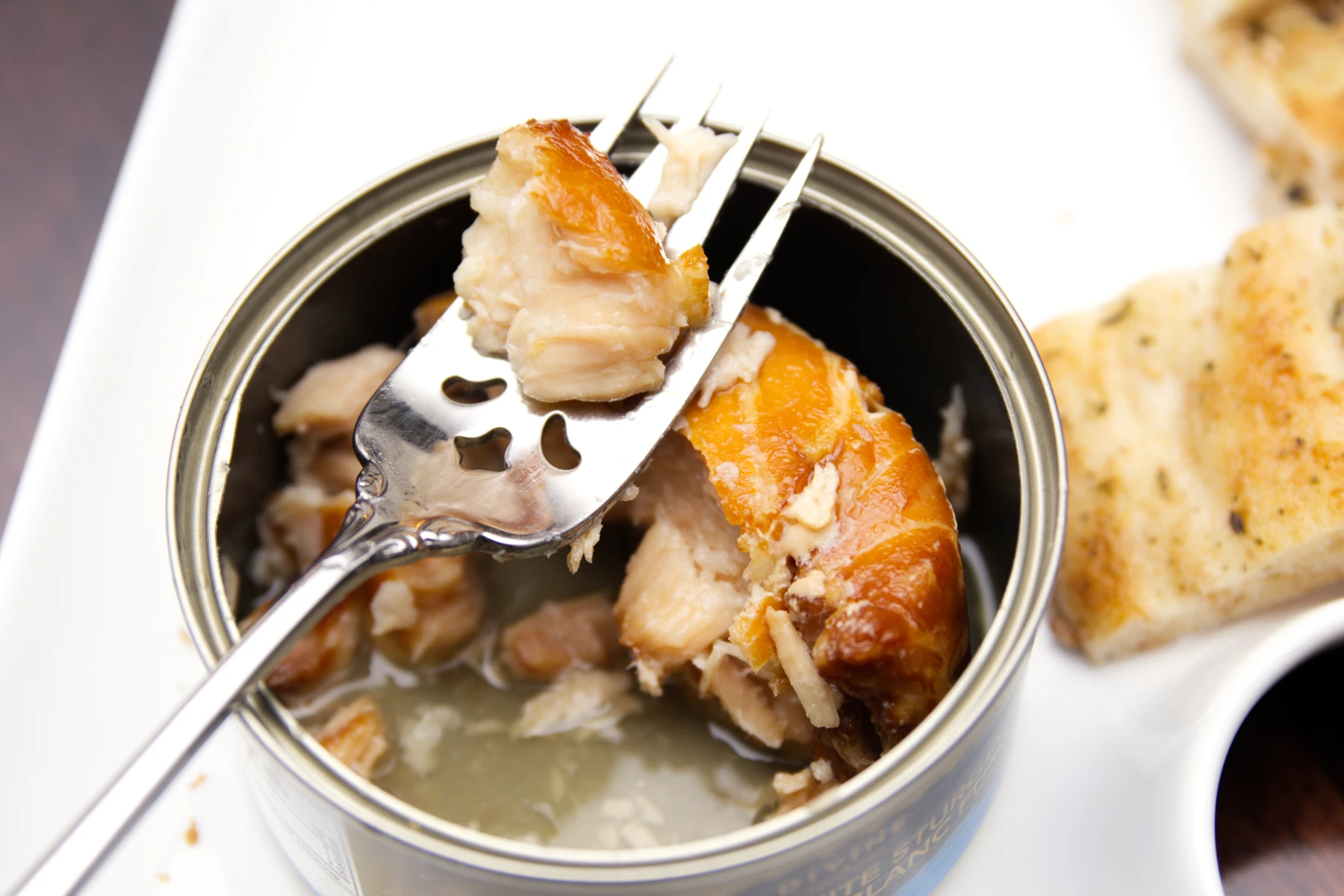 A piece of fatty sturgeon meat on a fork