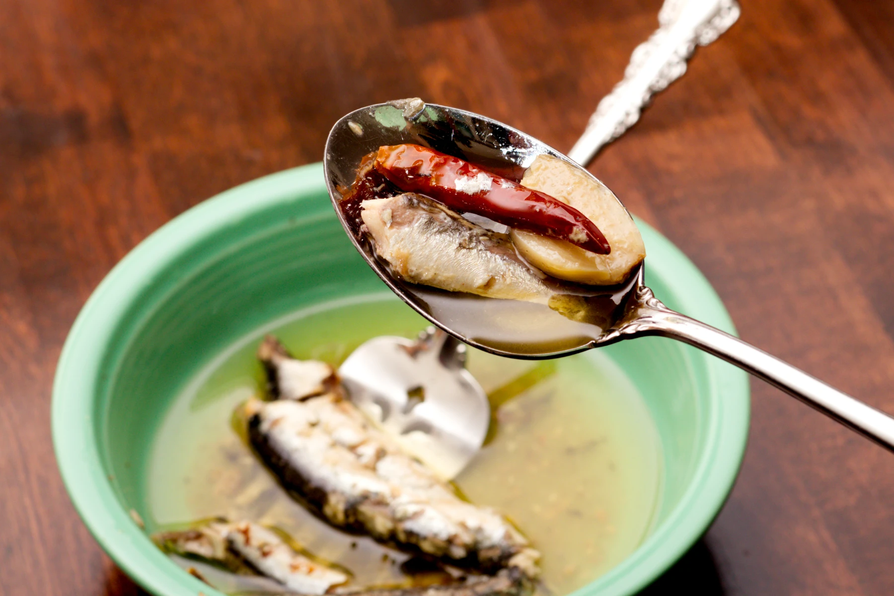 Closeup of anchovy, garlic, cayenne, and olive oil
