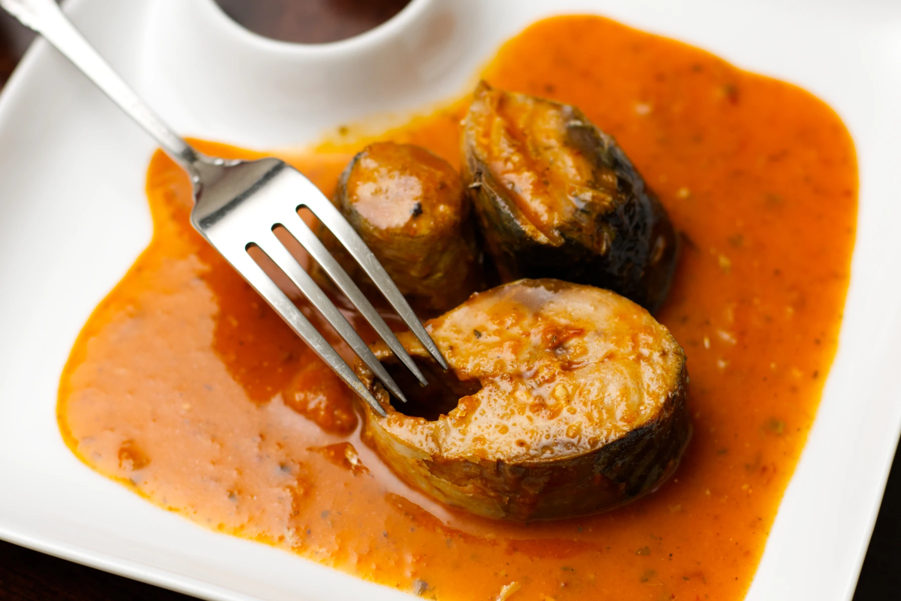 Mackerel with peppers & onion marinade on a plate.
